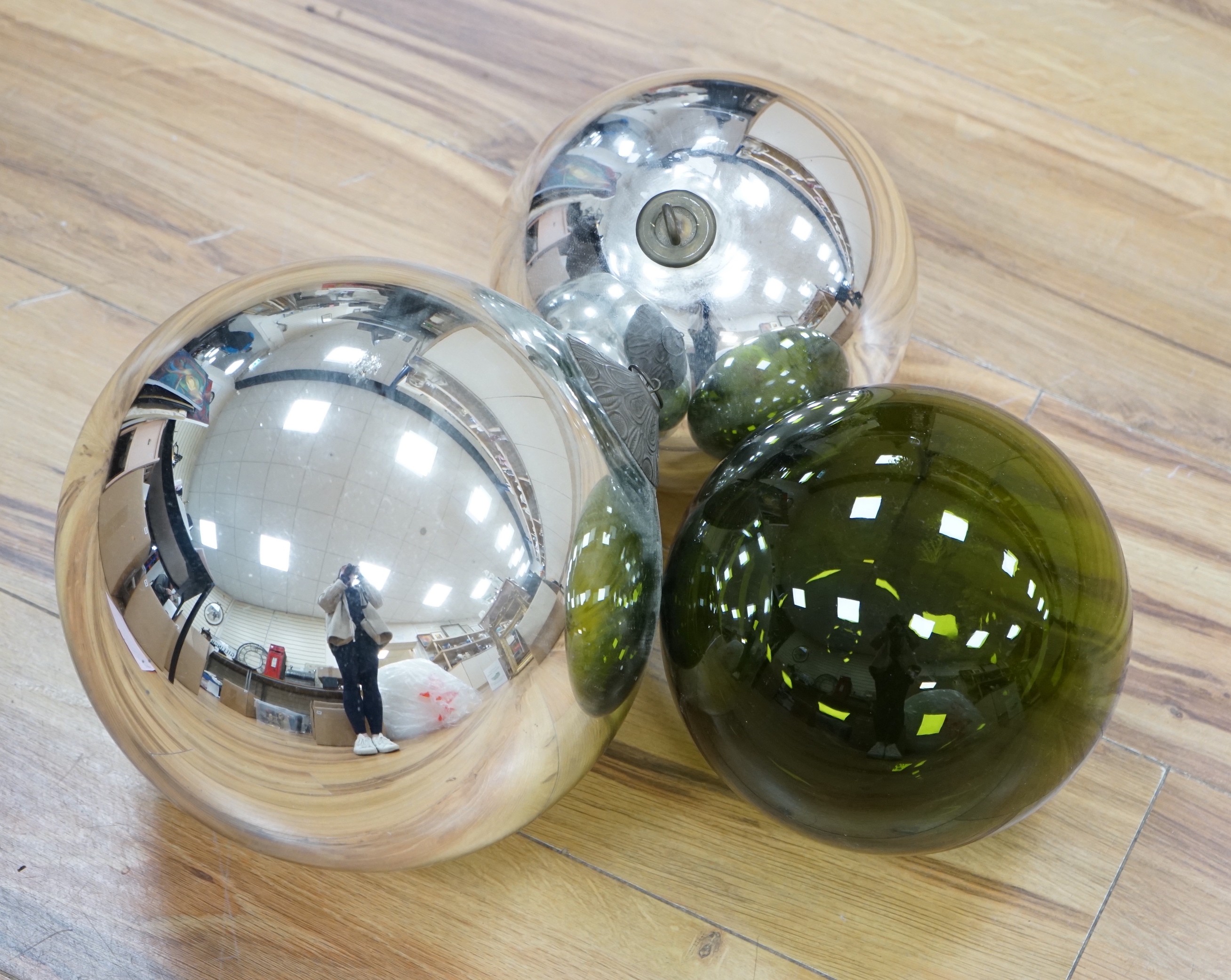 Two silvered glass witches balls and another